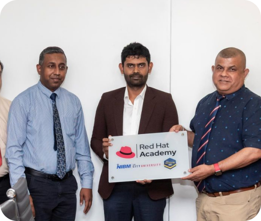 Representatives displaying a Red Hat Academy partnership plaque at NIBM Certification Hub Sri Lanka